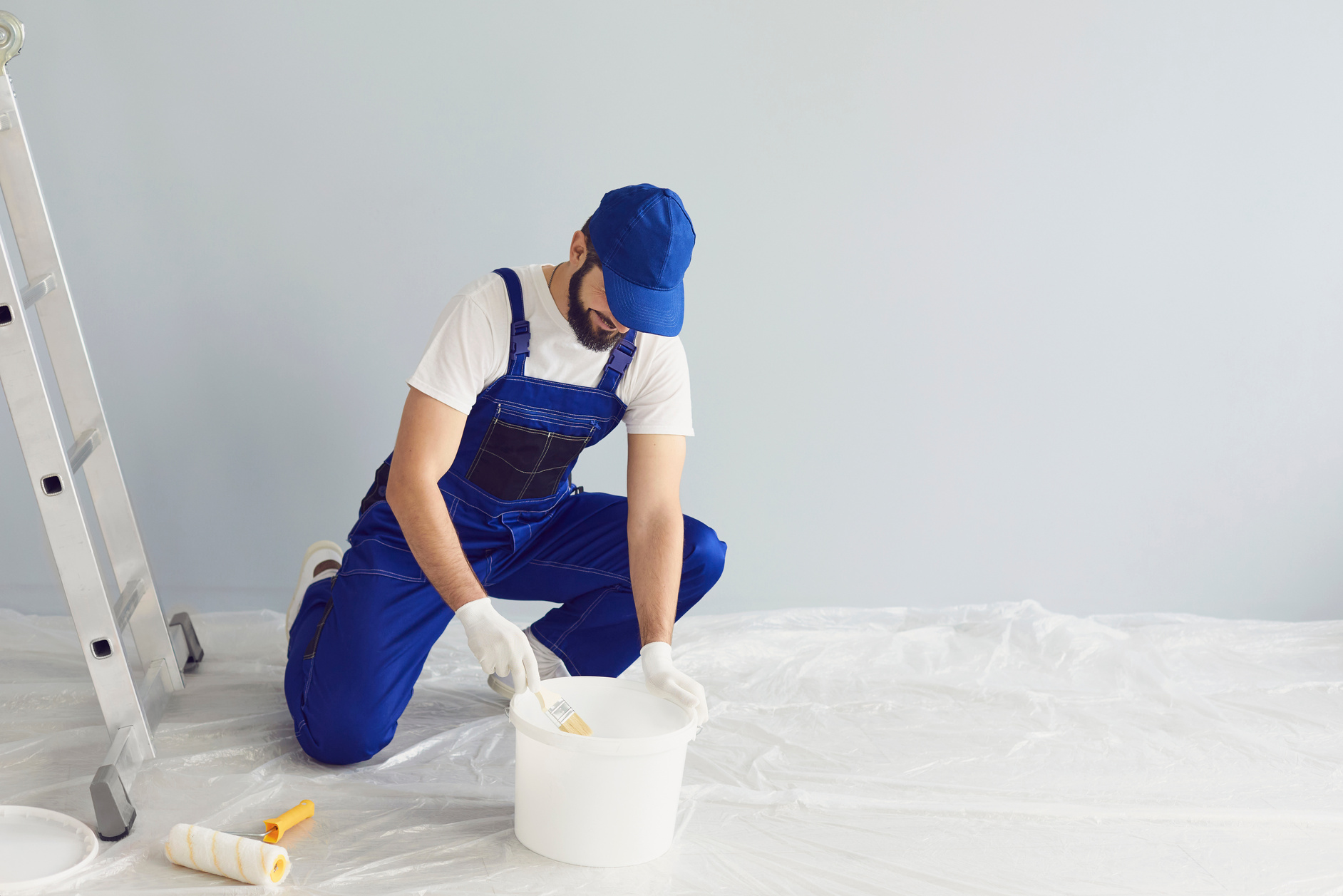 Bearded Worker Painter Taking Paint from Bucket